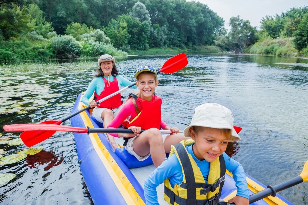 A family enjoying a camp-inspired outing at a Triangle-area creek, river, or lake.